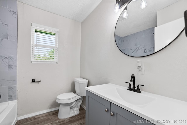 401 E 25th St, Okmulgee, OK 74447 - full bathroom with vanity, wood finished floors, toilet, a textured ceiling, and baseboards