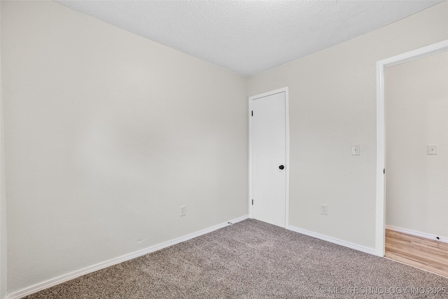401 E 25th St, Okmulgee, OK 74447 - unfurnished room with carpet, baseboards, and a textured ceiling