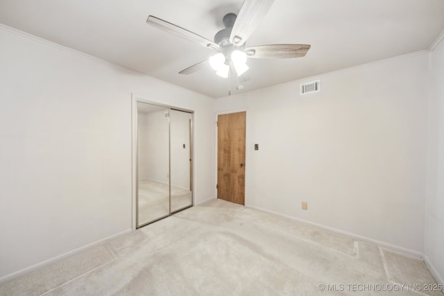 10925 E 4th St, Tulsa, OK 74128 - unfurnished bedroom featuring light colored carpet, a closet, crown molding, baseboards, and a ceiling fan