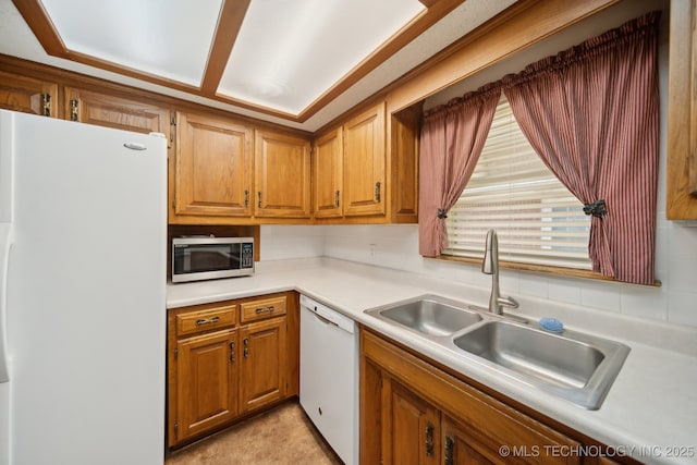 10925 E 4th St, Tulsa, OK 74128 - kitchen with white appliances, a sink, tasteful backsplash, light countertops, and brown cabinetry