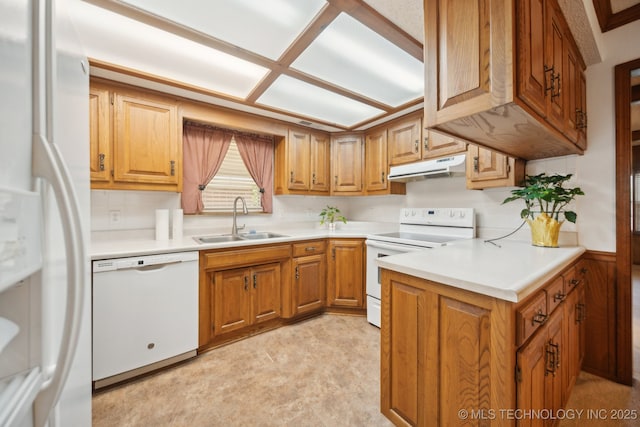 10925 E 4th St, Tulsa, OK 74128 - kitchen with white appliances, a sink, under cabinet range hood, and brown cabinetry
