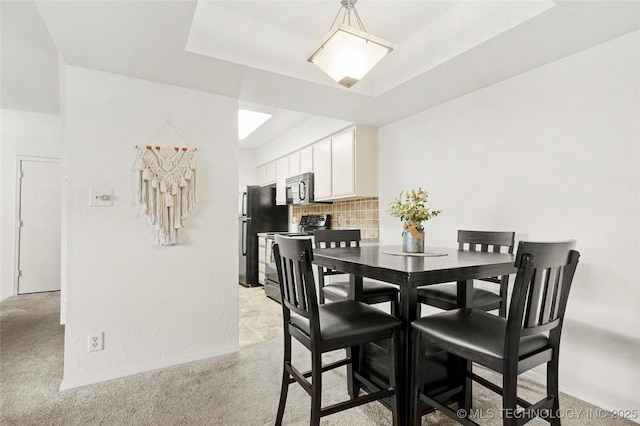 6374 S 80th E Ave Unit A, Tulsa, OK 74133 - dining room featuring light carpet, a tray ceiling, and baseboards