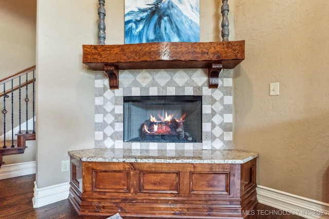 9512 N 144th E Ave, Owasso, OK 74055 - detailed view of a warm lit fireplace, wood finished floors, and baseboards