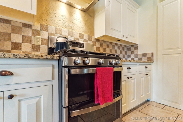 9512 N 144th E Ave, Owasso, OK 74055 - kitchen with range with two ovens, white cabinets, tasteful backsplash, light tile patterned floors, and light stone counters