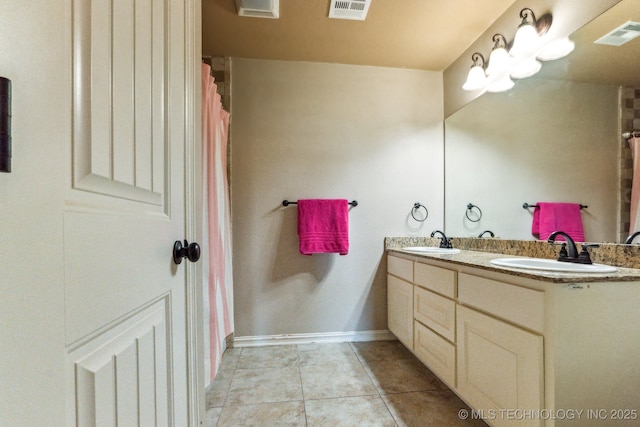 9512 N 144th E Ave, Owasso, OK 74055 - bathroom featuring double vanity, tile patterned floors, and baseboards
