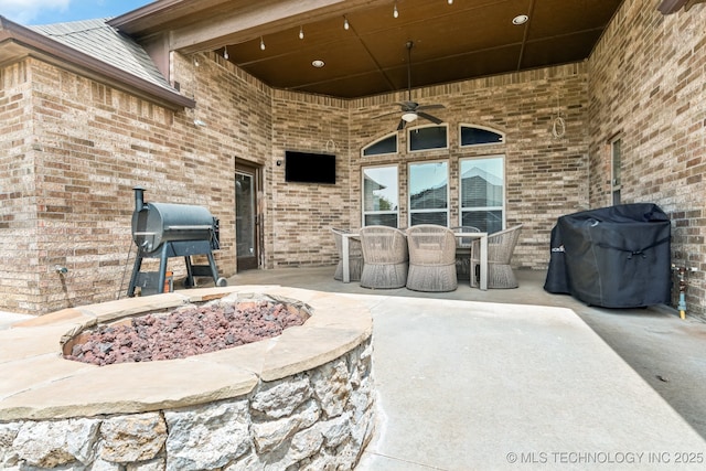 9512 N 144th E Ave, Owasso, OK 74055 - view of patio with a ceiling fan, a fire pit, a grill, and outdoor dining area
