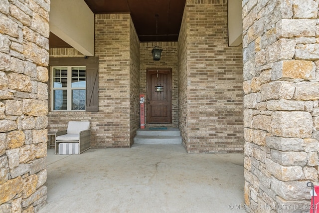 9512 N 144th E Ave, Owasso, OK 74055 - doorway to property featuring stone siding and brick siding