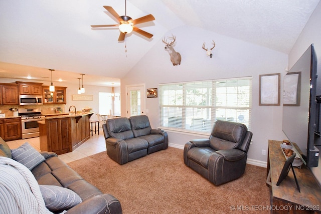 2570 Ambers Way, Tahlequah, OK 74464 - living area with ceiling fan, light carpet, high vaulted ceiling, and baseboards
