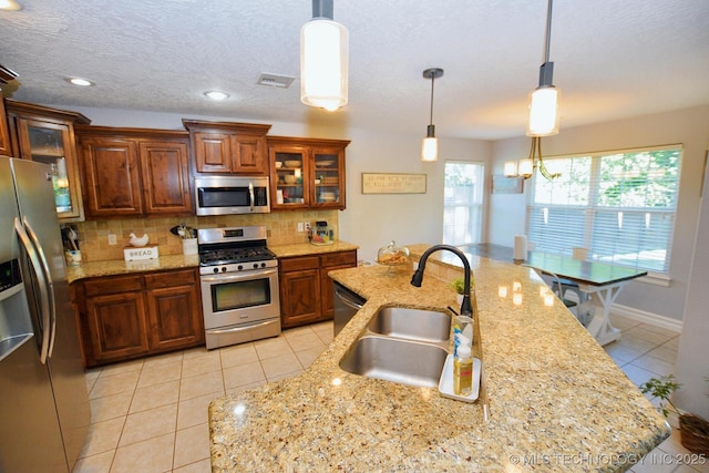 2570 Ambers Way, Tahlequah, OK 74464 - kitchen with stainless steel appliances, a sink, light tile patterned flooring, backsplash, and pendant lighting