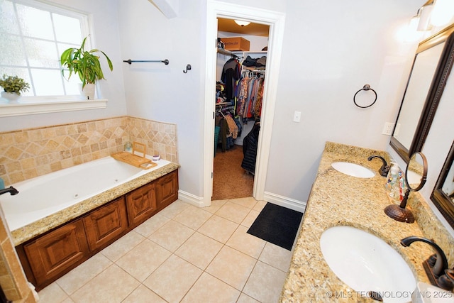 2570 Ambers Way, Tahlequah, OK 74464 - bathroom featuring double vanity, a garden tub, tile patterned floors, a spacious closet, and baseboards