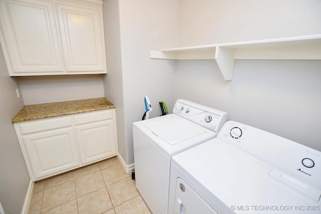 2570 Ambers Way, Tahlequah, OK 74464 - laundry area featuring washer and clothes dryer, cabinet space, light tile patterned flooring, and baseboards