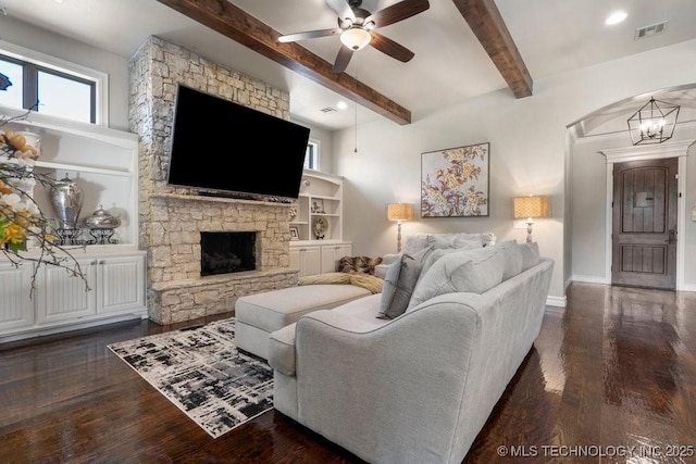 10406 N 86th E Ave, Owasso, OK 74055 - living room featuring ceiling fan, beam ceiling, dark wood-style floors, a stone fireplace, and baseboards