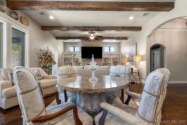 10406 N 86th E Ave, Owasso, OK 74055 - dining room featuring arched walkways, dark wood-type flooring, a ceiling fan, baseboards, and beamed ceiling