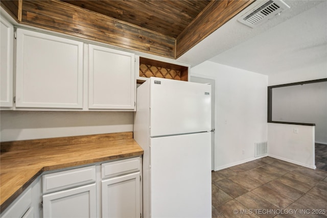8208 N 122nd E Ave, Owasso, OK 74055 - kitchen featuring freestanding refrigerator, butcher block countertops, wood ceiling, white cabinets, and baseboards