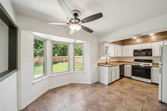 8208 N 122nd E Ave, Owasso, OK 74055 - kitchen with black appliances, a sink, a ceiling fan, baseboards, and light countertops