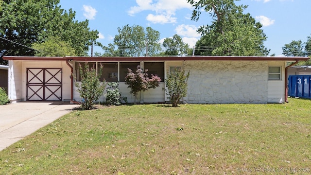 4921 E 26th St, Tulsa, OK 74114 - view of front facade featuring a front yard, driveway, and an attached garage