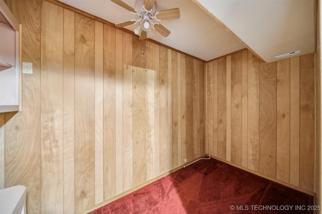 4921 E 26th St, Tulsa, OK 74114 - unfurnished room with a ceiling fan, wood walls, and dark colored carpet