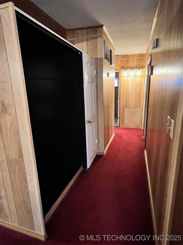 4921 E 26th St, Tulsa, OK 74114 - corridor with dark colored carpet and wood walls