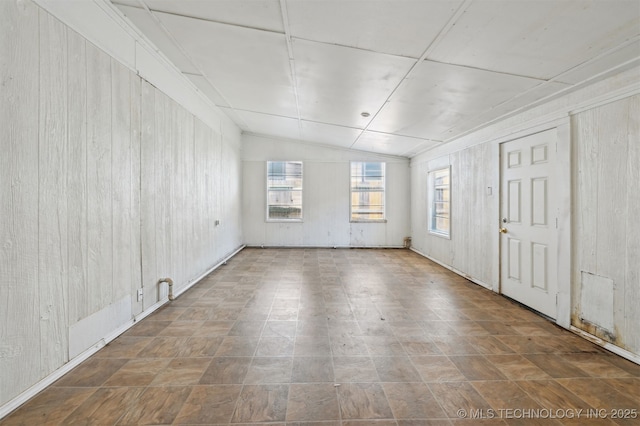 1604 E 55th Pl, Tulsa, OK 74105 - spare room with wooden walls and vaulted ceiling