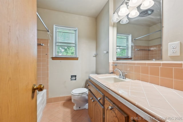 1604 E 55th Pl, Tulsa, OK 74105 - full bathroom with plenty of natural light, vanity, toilet, and shower / washtub combination