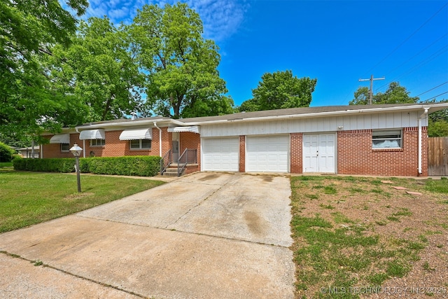 1604 E 55th Pl, Tulsa, OK 74105 - ranch-style home featuring brick siding, a garage, concrete driveway, and board and batten siding