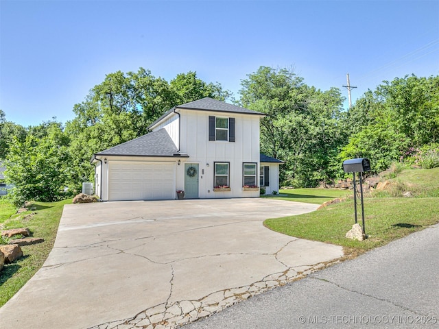 228 W Ohio Ave, Kiefer, OK 74041 - view of front of property featuring board and batten siding, driveway, a front yard, a garage, and roof with shingles