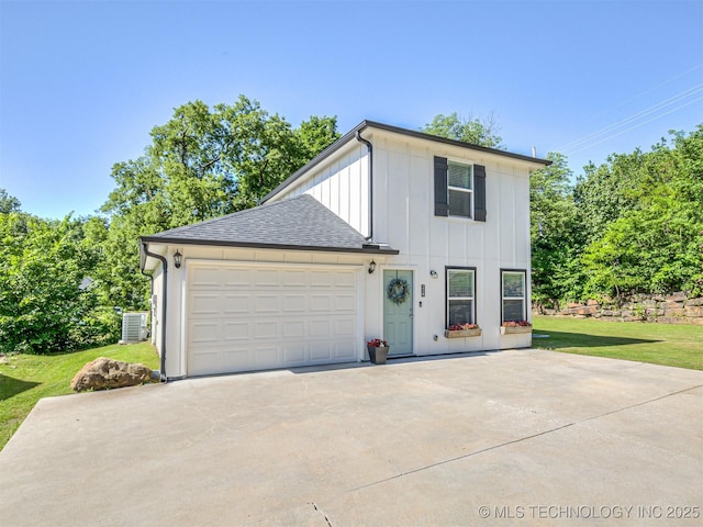 228 W Ohio Ave, Kiefer, OK 74041 - view of front facade featuring board and batten siding, concrete driveway, central AC unit, a front lawn, and a garage