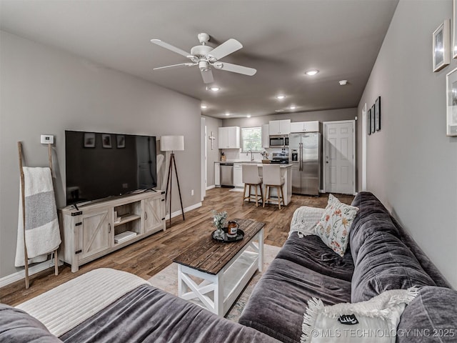 228 W Ohio Ave, Kiefer, OK 74041 - living room featuring light wood-type flooring, baseboards, ceiling fan, and recessed lighting