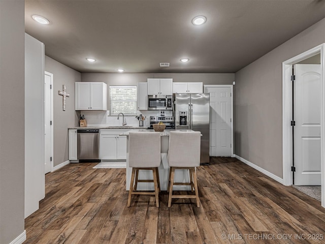 228 W Ohio Ave, Kiefer, OK 74041 - kitchen featuring appliances with stainless steel finishes, baseboards, white cabinetry, a center island, and recessed lighting