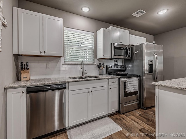 228 W Ohio Ave, Kiefer, OK 74041 - kitchen featuring appliances with stainless steel finishes, a sink, recessed lighting, dark wood-style flooring, and tasteful backsplash