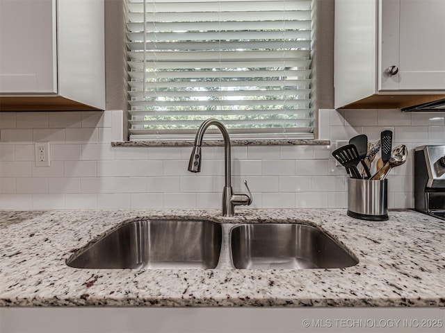228 W Ohio Ave, Kiefer, OK 74041 - kitchen view of a sink, decorative backsplash, light stone counters, and white cabinets