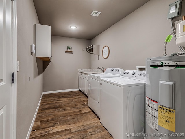 228 W Ohio Ave, Kiefer, OK 74041 - washroom featuring water heater, cabinet space, washing machine and clothes dryer, dark wood finished floors, and baseboards