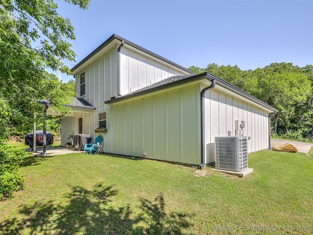 228 W Ohio Ave, Kiefer, OK 74041 - back of property featuring cooling unit, a lawn, board and batten siding, and a patio area