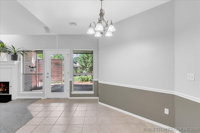 3000 S Tamarack Ave, Broken Arrow, OK 74012 - doorway featuring a chandelier, a warm lit fireplace, tile patterned floors, and baseboards