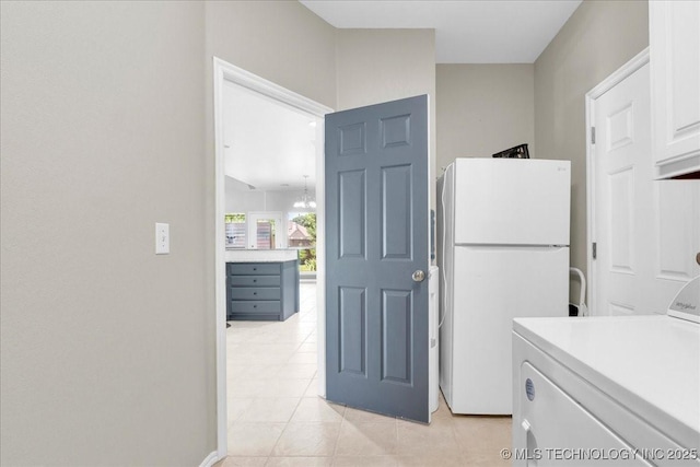 3000 S Tamarack Ave, Broken Arrow, OK 74012 - laundry room featuring washer / clothes dryer and light tile patterned floors