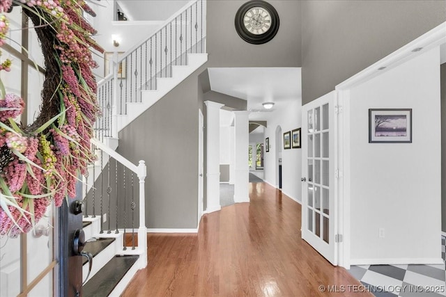 3000 S Tamarack Ave, Broken Arrow, OK 74012 - foyer entrance with french doors, a high ceiling, stairs, baseboards, and wood finished floors