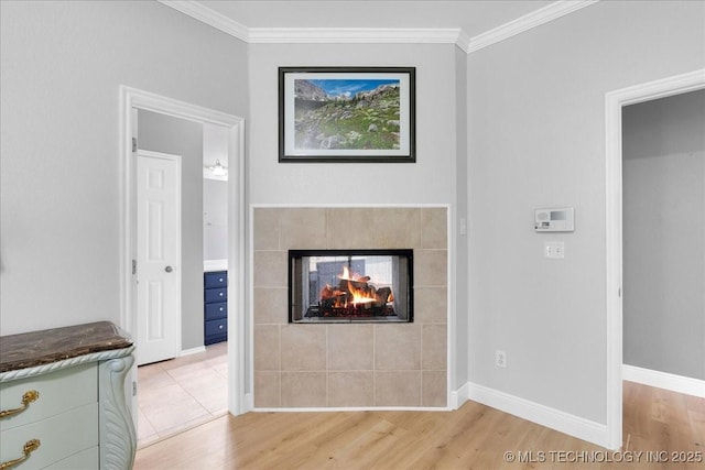 3000 S Tamarack Ave, Broken Arrow, OK 74012 - unfurnished living room featuring light wood-style floors, ornamental molding, a tile fireplace, and baseboards