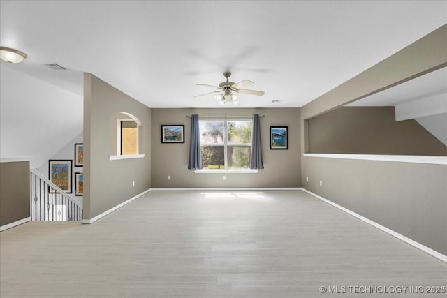 3000 S Tamarack Ave, Broken Arrow, OK 74012 - unfurnished living room featuring ceiling fan, wood finished floors, baseboards, and lofted ceiling