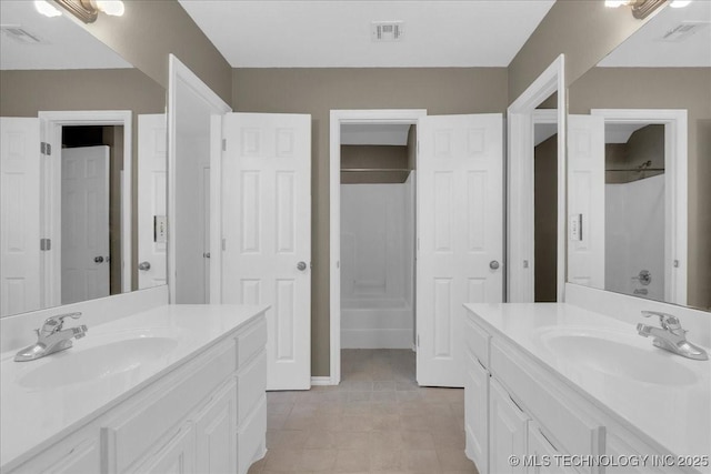 3000 S Tamarack Ave, Broken Arrow, OK 74012 - bathroom featuring two vanities, a shower, and tile patterned flooring