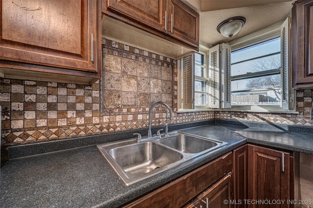 506 W 17th, Sulphur, OK 73086 - kitchen featuring a sink, dark countertops, backsplash, and dark brown cabinets