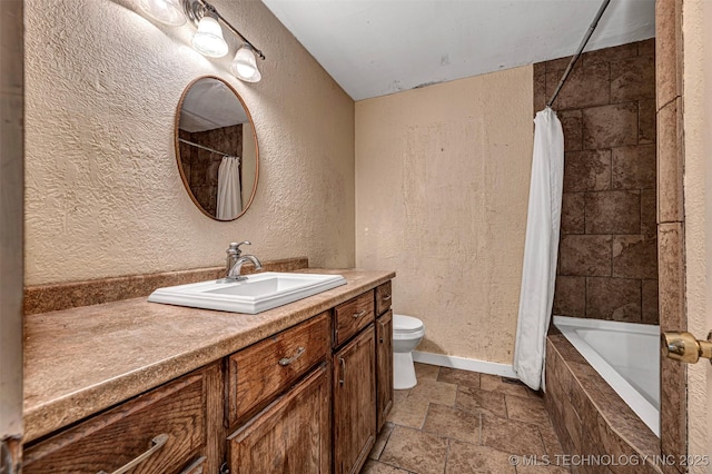 506 W 17th, Sulphur, OK 73086 - full bath featuring stone tile flooring, a textured wall, toilet, vanity, and tiled shower / bath combo