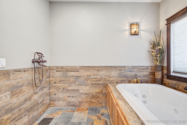 4748 N 4318th Rd, Pryor, OK 74361 - full bathroom featuring a jetted tub and stone finish floors