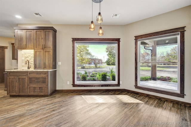 4748 N 4318th Rd, Pryor, OK 74361 - unfurnished dining area featuring light wood-type flooring, baseboards, and a sink