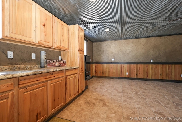 4748 N 4318th Rd, Pryor, OK 74361 - kitchen with a wainscoted wall and light stone countertops