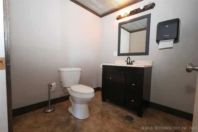 4748 N 4318th Rd, Pryor, OK 74361 - bathroom with baseboards, toilet, vanity, vaulted ceiling, and tile patterned floors