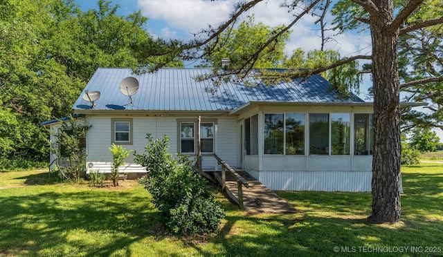 33321 S 4470th Rd, Vinita, OK 74301 - rear view of house with a lawn, a sunroom, and metal roof