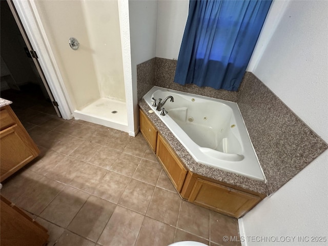 905 Brookside Dr, Durant, OK 74701 - full bath with a tub with jets, a shower stall, and tile patterned flooring