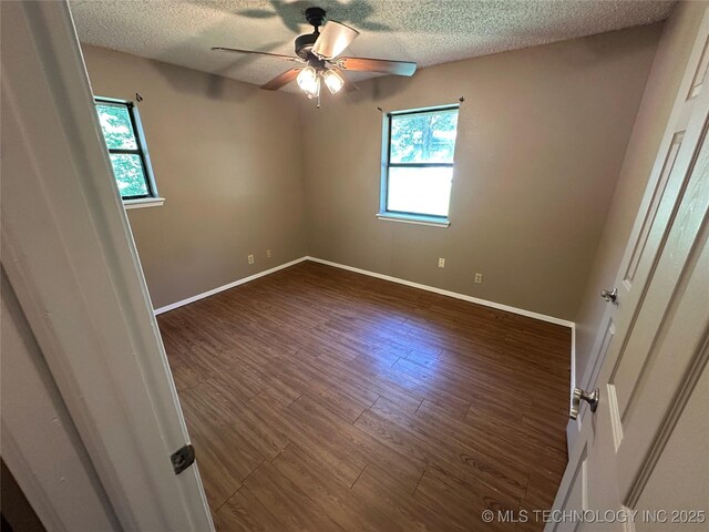 905 Brookside Dr, Durant, OK 74701 - spare room featuring a ceiling fan, a textured ceiling, wood finished floors, and baseboards
