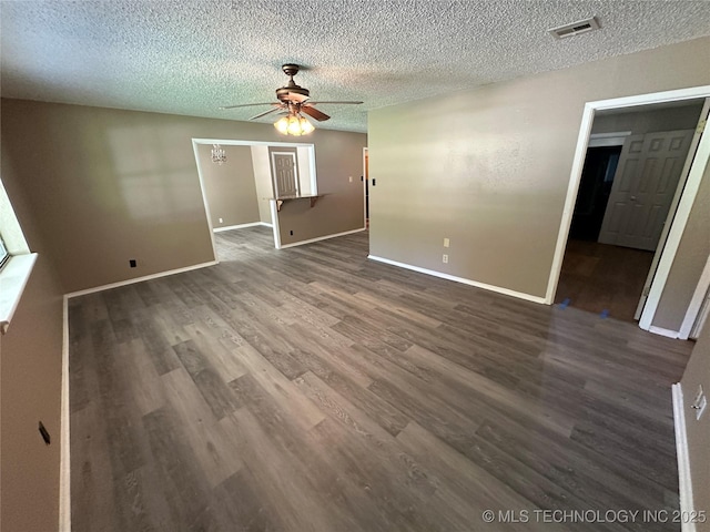905 Brookside Dr, Durant, OK 74701 - empty room with a ceiling fan, dark wood-type flooring, baseboards, and a textured ceiling