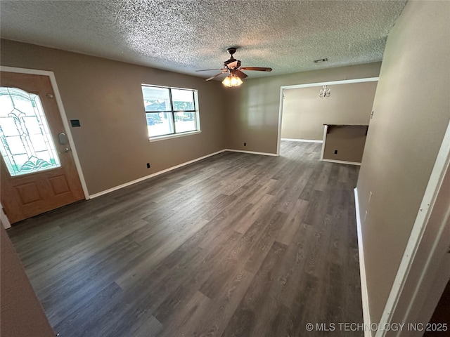 905 Brookside Dr, Durant, OK 74701 - foyer with dark wood finished floors, a textured ceiling, baseboards, and ceiling fan
